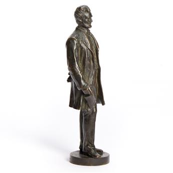 (ABRAHAM LINCOLN.) George E. Bissell, sculptor. Statuette of Lincoln standing with the Emancipation Proclamation.